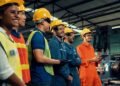 Skillful worker attending brief meeting in the factory . Industrial people and manufacturing labor concept .