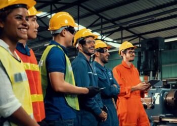 Skillful worker attending brief meeting in the factory . Industrial people and manufacturing labor concept .