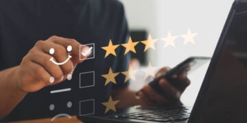 Online customer service and satisfaction survey concept with internet technology. Finger of businessman touching and check mark icon face emoticon smile, service mind, service rating. Work from home.