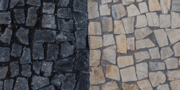 A textured stone wall featuring a variety of colors and patterns, showcasing natural stone elements.